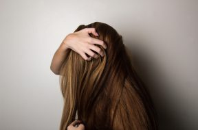 photo-of-woman-covering-face-with-her-hair-1159334