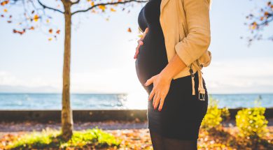 pregnant-woman-wearing-beige-long-sleeve-shirt-standing-near-132730