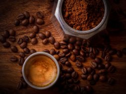 white-ceramic-mug-filled-with-coffee-beside-coffee-beans-678654