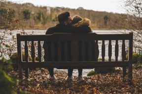 photo-of-couple-sitting-on-bench-3404388