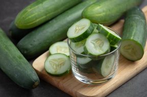 fresh cucumbers sliced on dark background