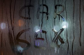 the words car sex written by finger on sweaty night window glass - close-up in horizontal orientation