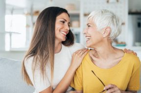 Modern senior woman and her adult daughter happy together