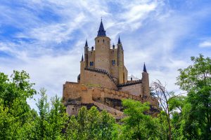 Panoramic view of the medieval castle, Alcazar de Segovia, rising majestically to the sky.