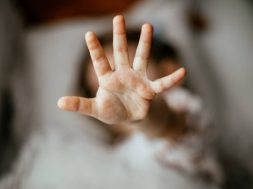 A girl showing 5 with her fingers