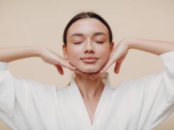 Young woman doing face building facial gymnastics self massage