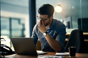 Shot of a young businessman experiencing stress during a late night at work