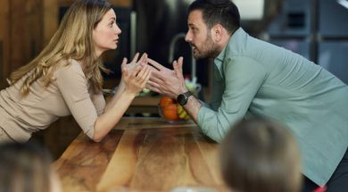 Frustrated parents having an argument in the kitchen.