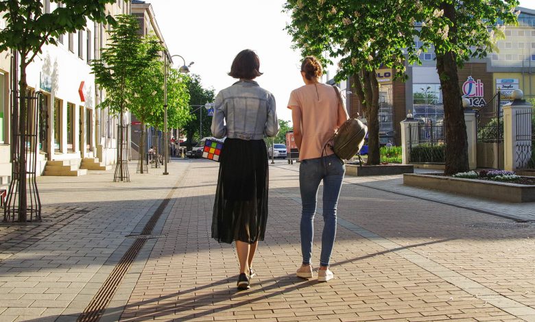 photo-of-women-walking-down-the-street-1116984